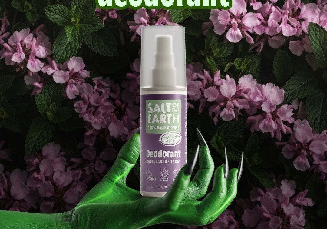 Halloween-themed image showing Salt of the Earth Sage & Mint natural refillable deodorant spray held by a green hand among purple flowers, promoting the ‘SUPERnatural’ deodorant campaign.