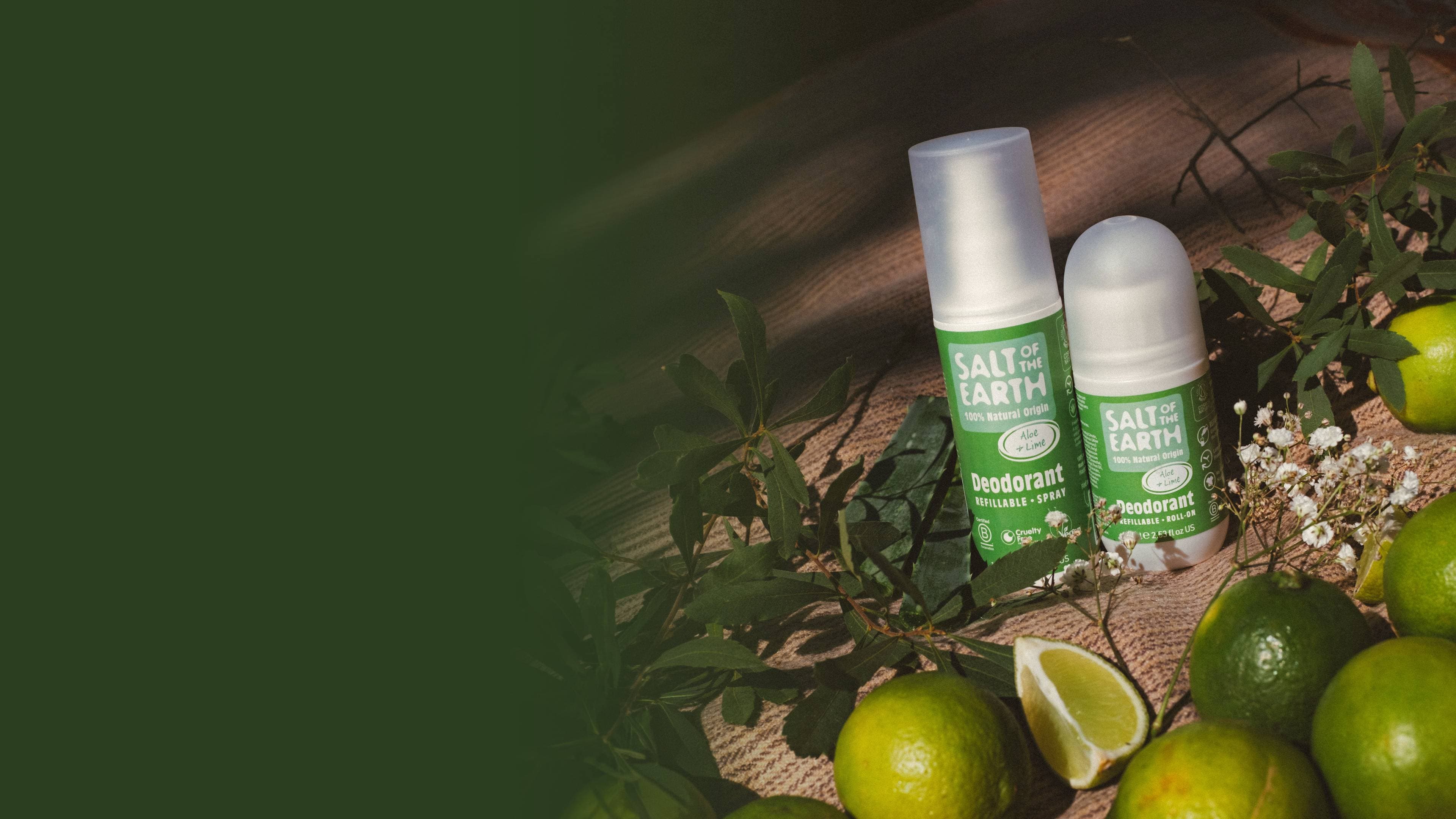 Salt of the Earth Aloe & Lime natural deodorant spray and roll-on beside fresh limes